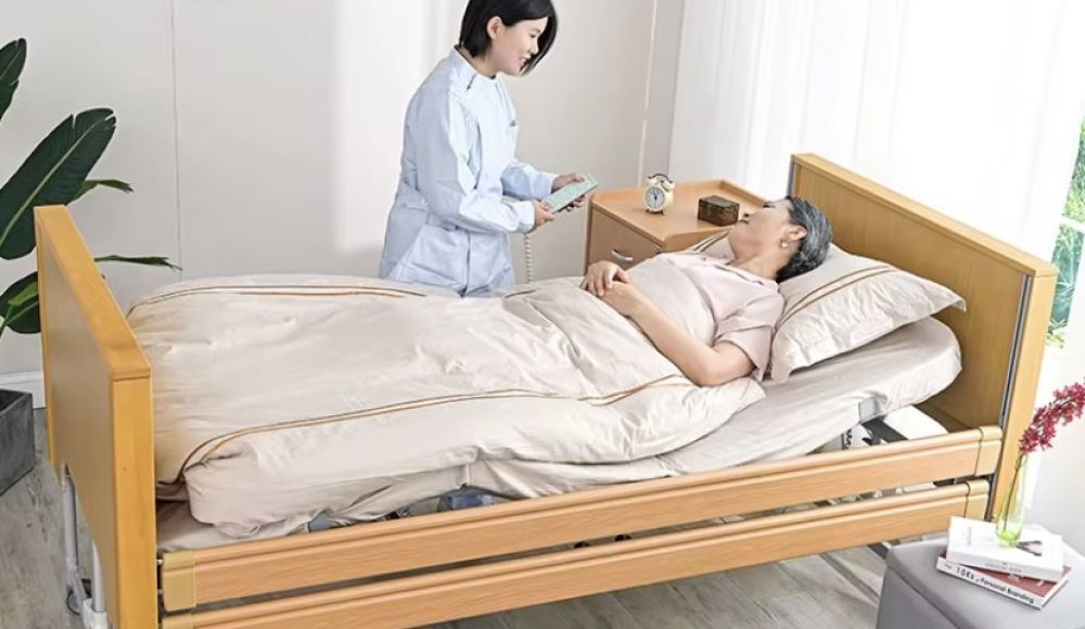 Caregiver assisting an elderly patient resting in a hospital bed.